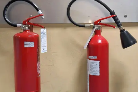 Portable fire extinguishers mounted on a wall