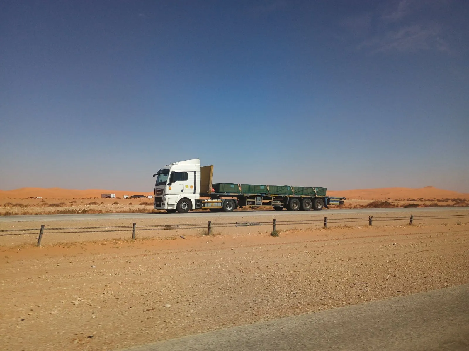Flatbed truck on a flat desert highway